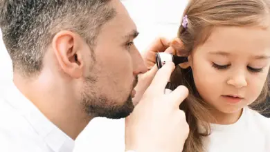 Doctor examining child's ear