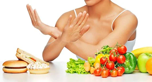 Woman rejecting junk food for healthy options