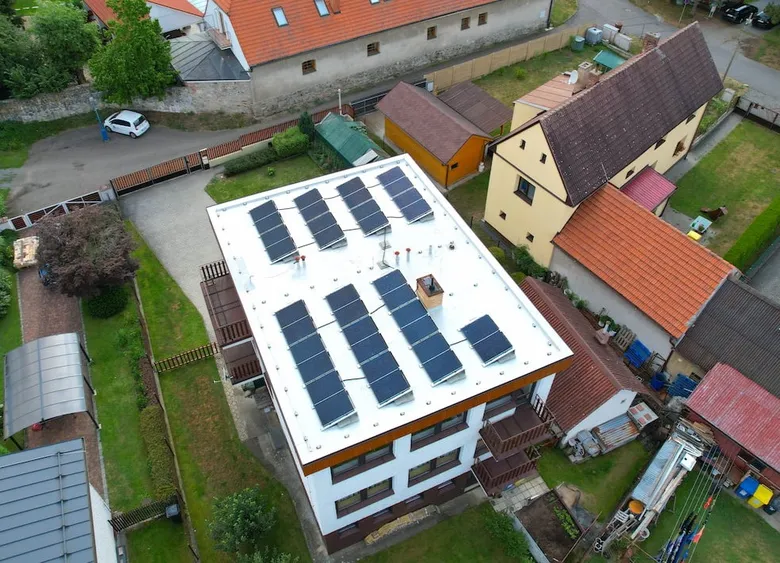 Vzdušný pohled na střechu s fotovoltaickými panely.